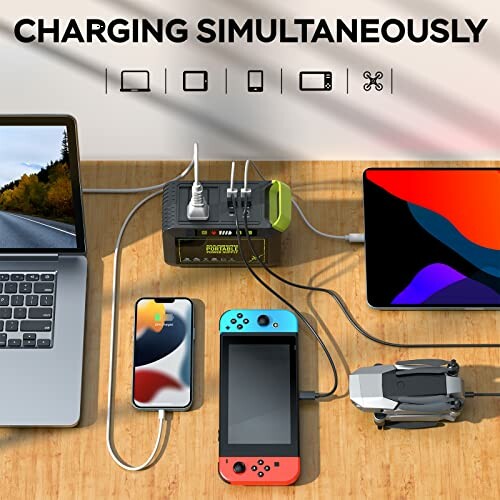 Multiple devices charging on a power station with various cables.