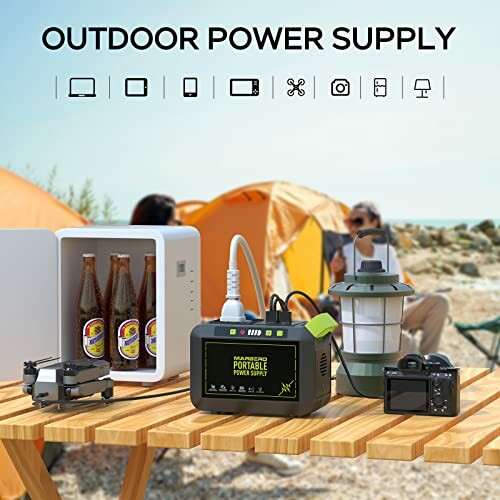 Portable power supply on table with mini fridge, lantern, camera, and drone at campsite.