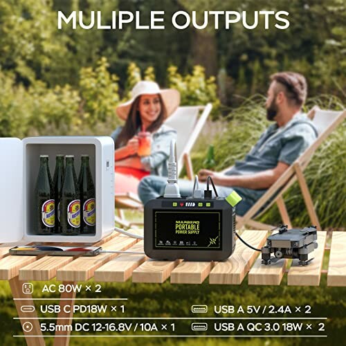Portable power supply on a table powering a mini fridge and other devices outdoors.