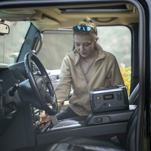 Woman in car using a portable generator.